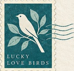 A teal postage stamp showing a pale bird on a leafy branch above the words Lucky Love Birds.